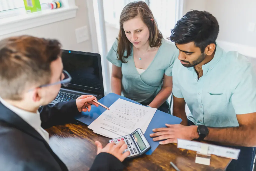 An attorney going over paperwork with a couple. 