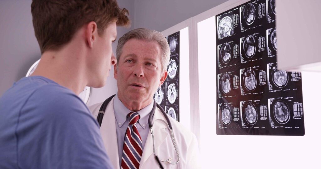 A doctor going over scans with patient.