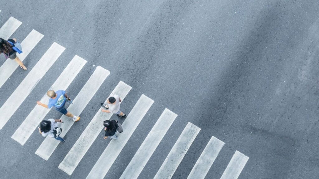 People walking across a crosswalk.