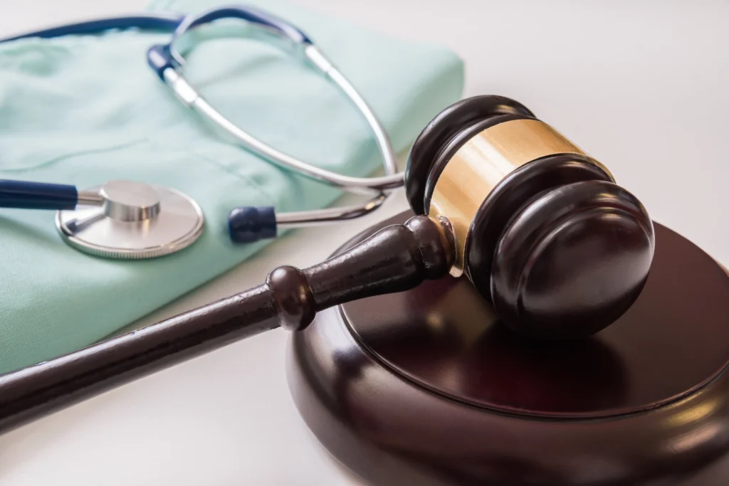 A stethoscope sitting with a gavel.